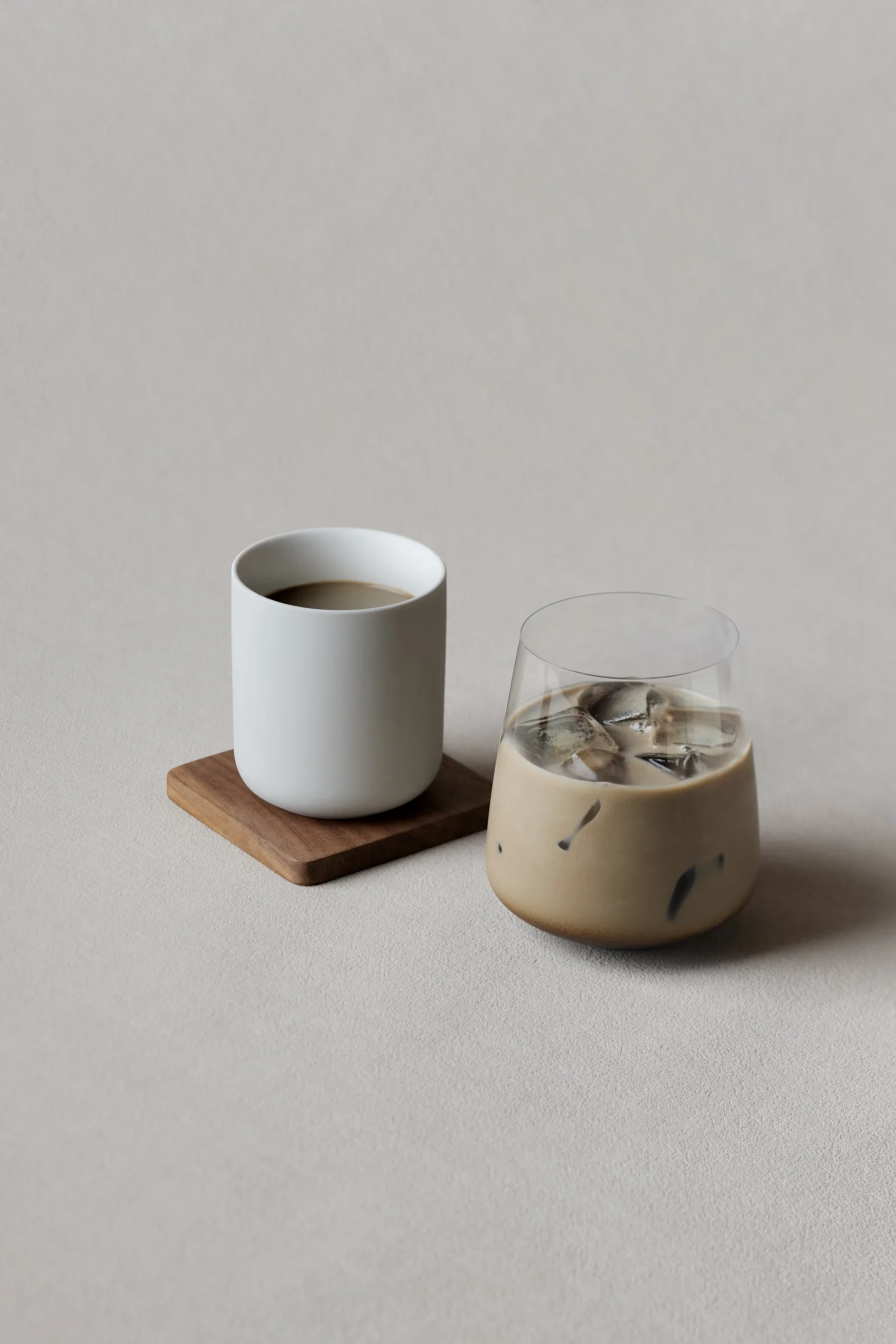 A matcha latte and a bowl of thin-whisked usucha side by side