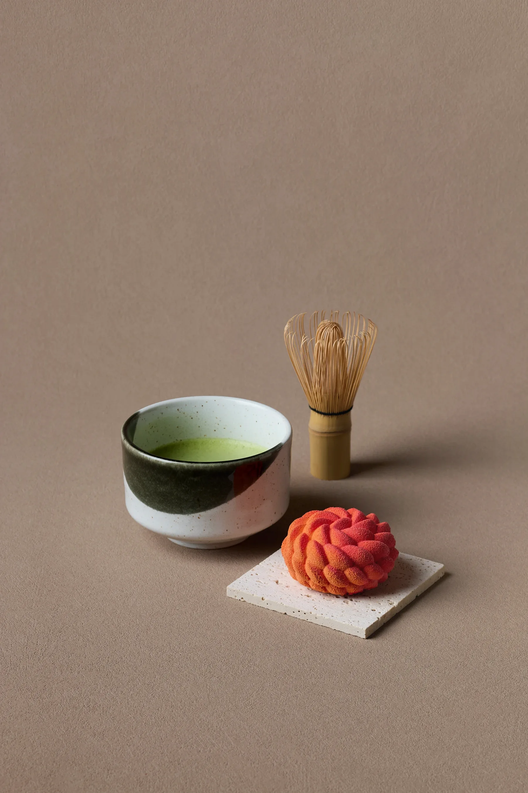 A Japanese confection served beside a bowl of single-origin usucha